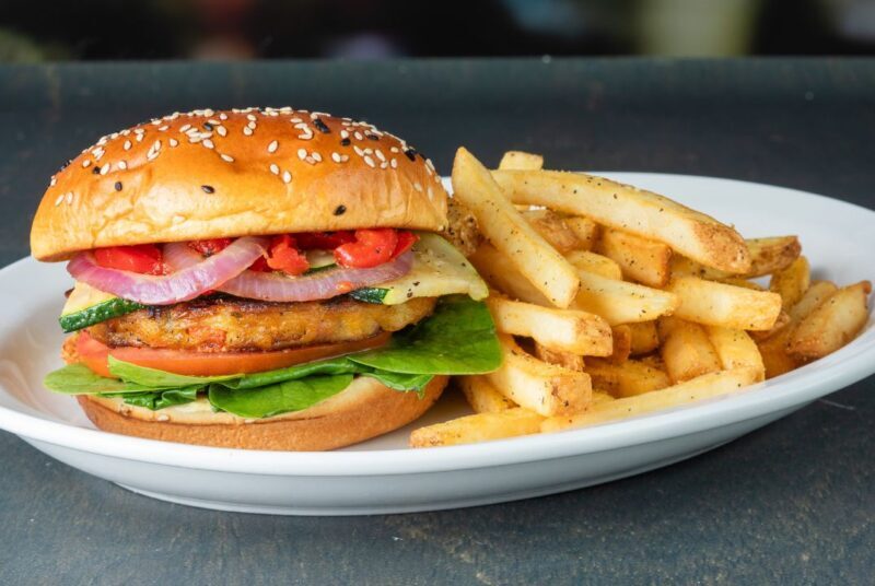 a miller's veggie burger on a plate with fries